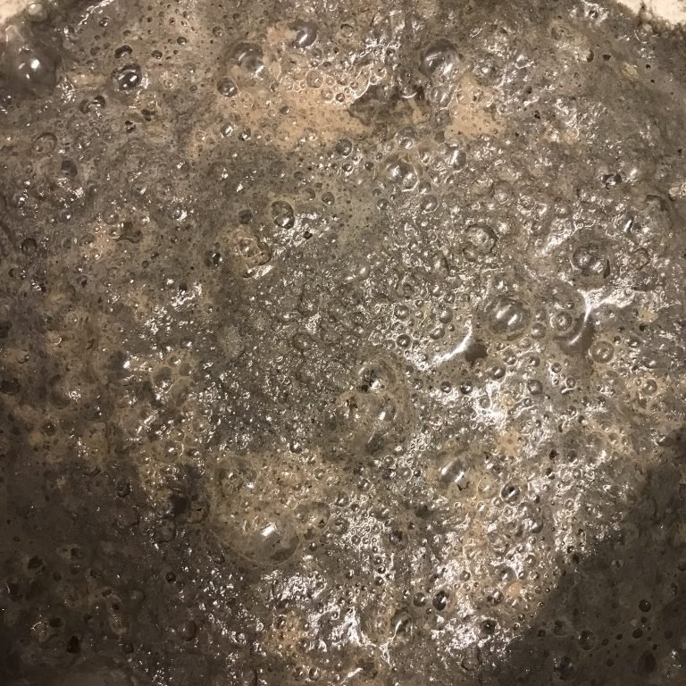 Wood ash getting washed and bubbling